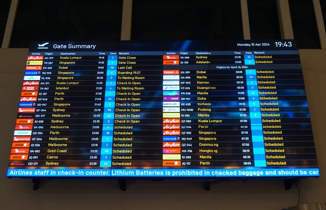 a-large-screen-displaying-a-flight-schedule-at-an-airport-cbheej0imeo